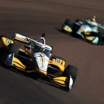 Josef Newgarden (Penske) emerges on the Phoenix oval, Romain Grosjean (Coyne) out of luck